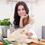 Juicy shredded chicken in a bowl with herbs, showing a tender texture from an easy shredded chicken recipe.
