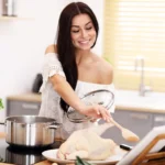 Homemade chicken gravy in a bowl served with rice, rich and creamy sauce with tender chicken pieces and fresh herbs