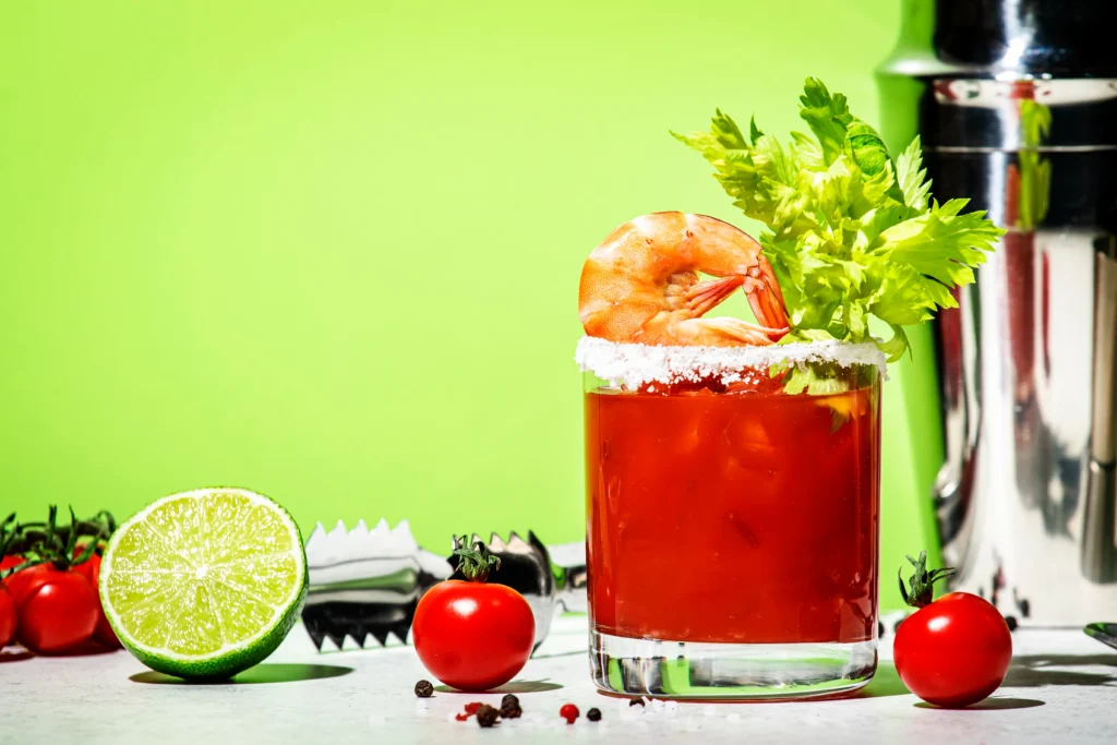 Flavor-packed Bloody Mary cocktail garnished with celery, lemon, olives, and spices in a tall glass.