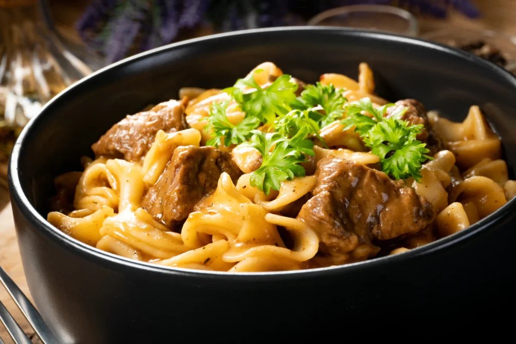 Slow cooker beef and noodles served in a creamy sauce, tender beef and egg noodles in a comforting homemade dish
