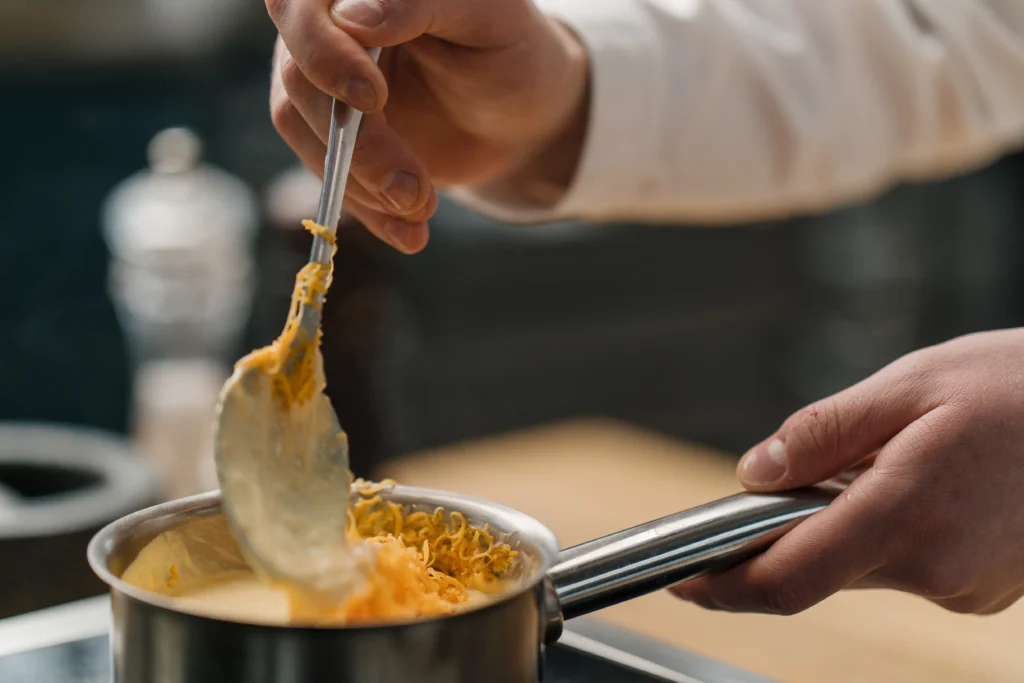 Cheddar cheese sauce recipe in a creamy pan, smooth and glossy melted sauce perfect for dipping and drizzling.