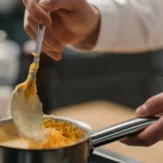 Cheddar cheese sauce recipe in a creamy pan, smooth and glossy melted sauce perfect for dipping and drizzling.