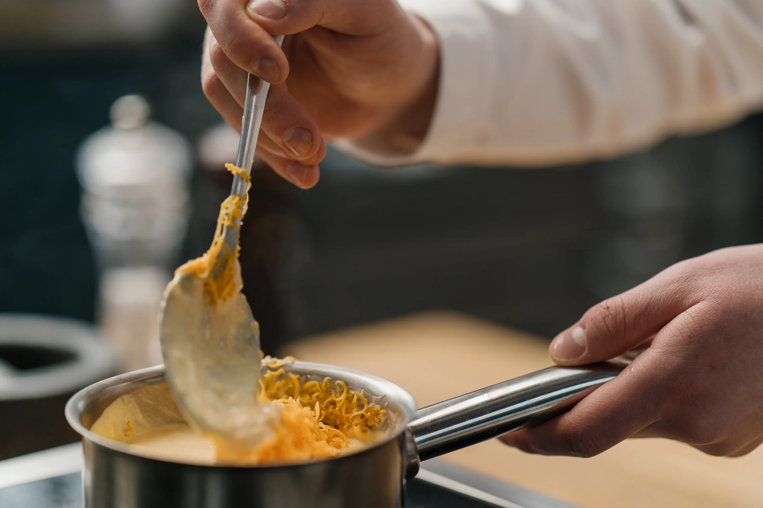 Cheddar cheese sauce recipe in a creamy pan, smooth and glossy melted sauce perfect for dipping and drizzling.