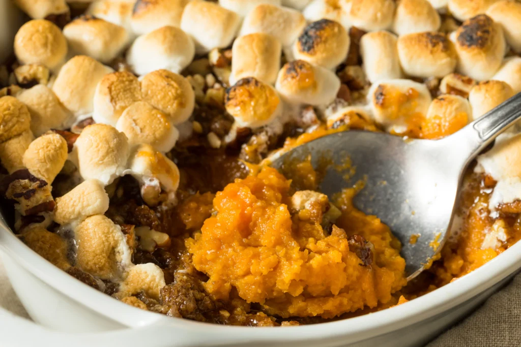 Easy candied yams recipe with marshmallows and cinnamon in a baked dish