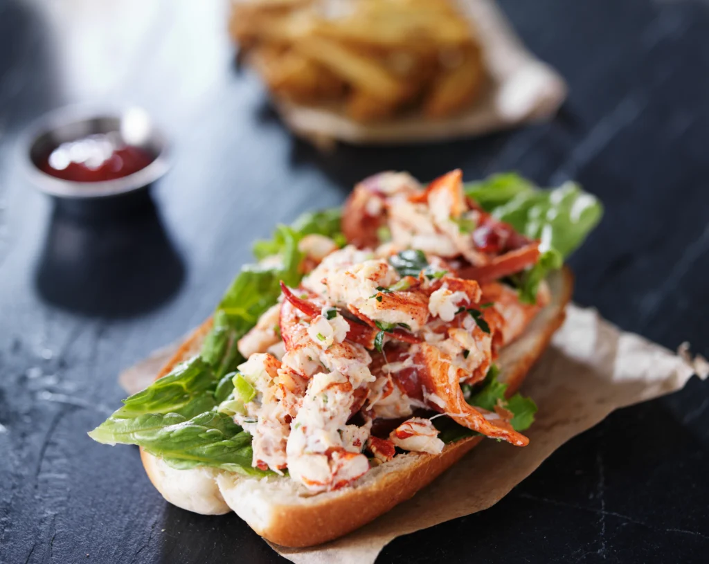 Buttery lobster roll served in a toasted bun with fresh herbs and melted butter