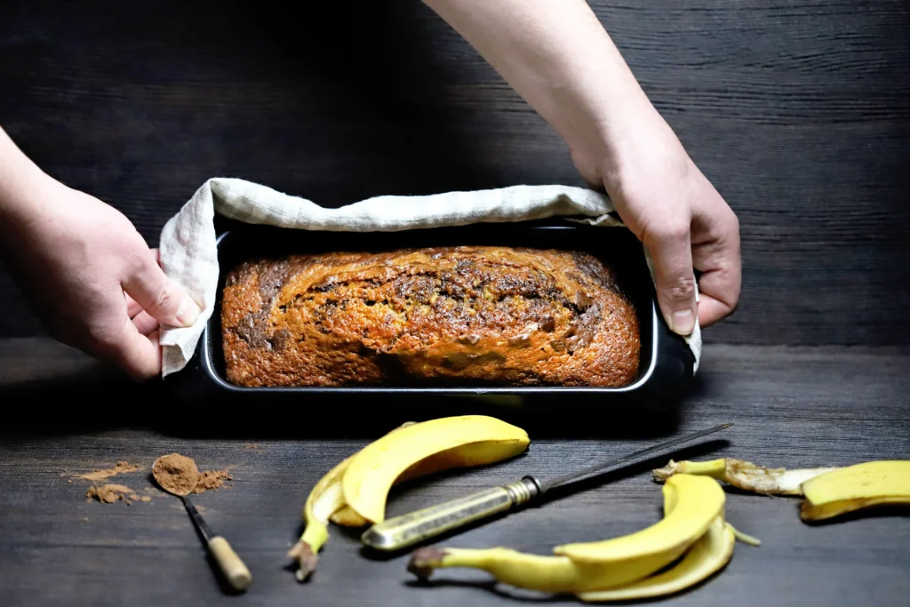 Banana Bread Recipe
Freshly baked chocolate chip banana bread sliced on a wooden board, filled with melted chocolate chips and made with ripe bananas, perfect for beginner bakers.
