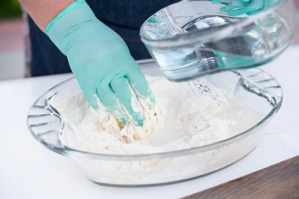 Amazing oobleck recipe showing slime-like non-Newtonian fluid made from cornstarch and water in a bowl