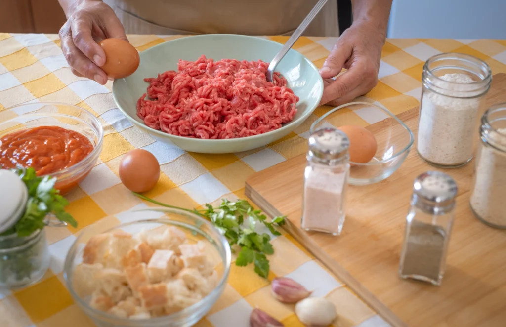 Turkey meatballs simmering in rich tomato sauce in a skillet, served with fresh herbs on top.