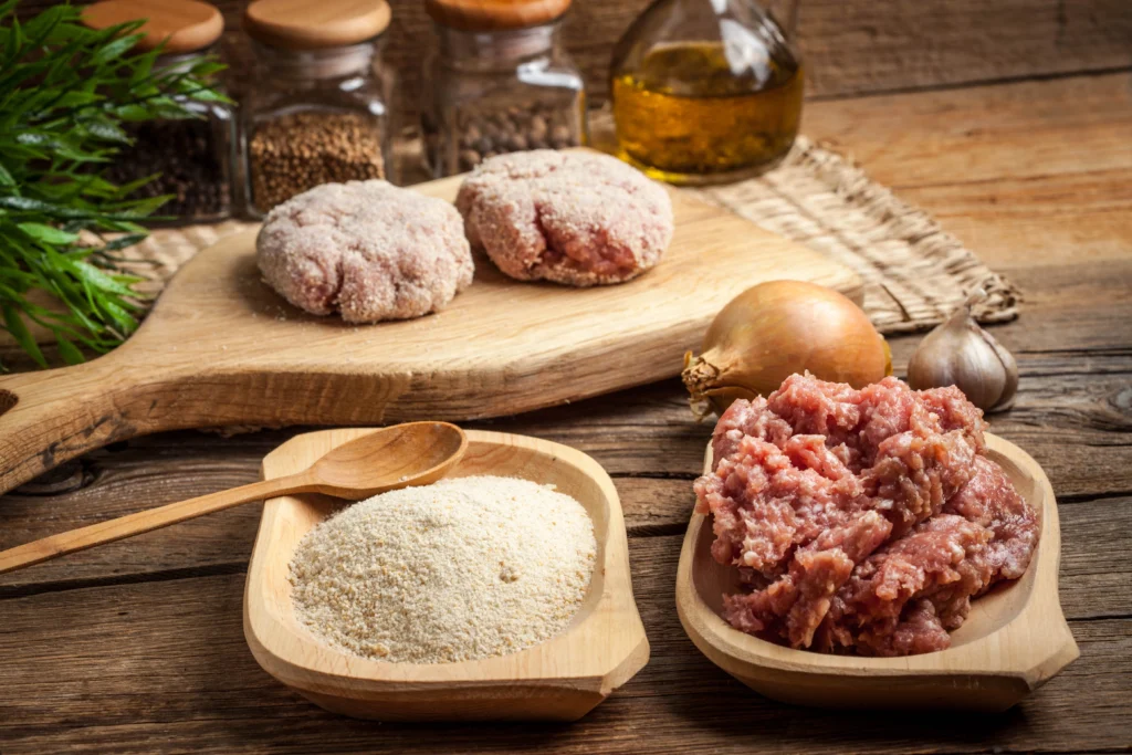 Turkey meatballs simmering in rich tomato sauce in a skillet, served with fresh herbs on top.