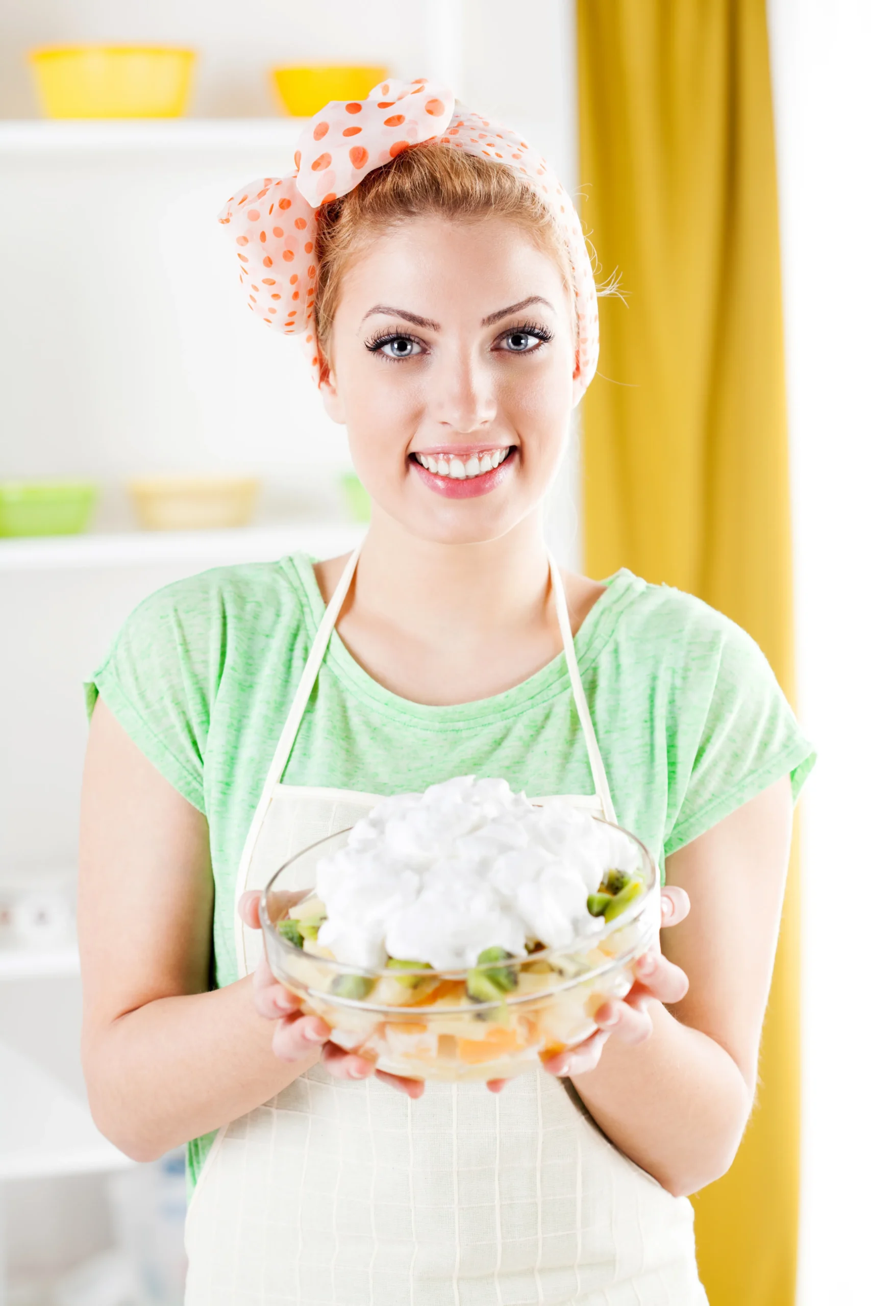 Creamy homemade grape salad with red and green grapes, topped with brown sugar and chopped pecans in a bowl