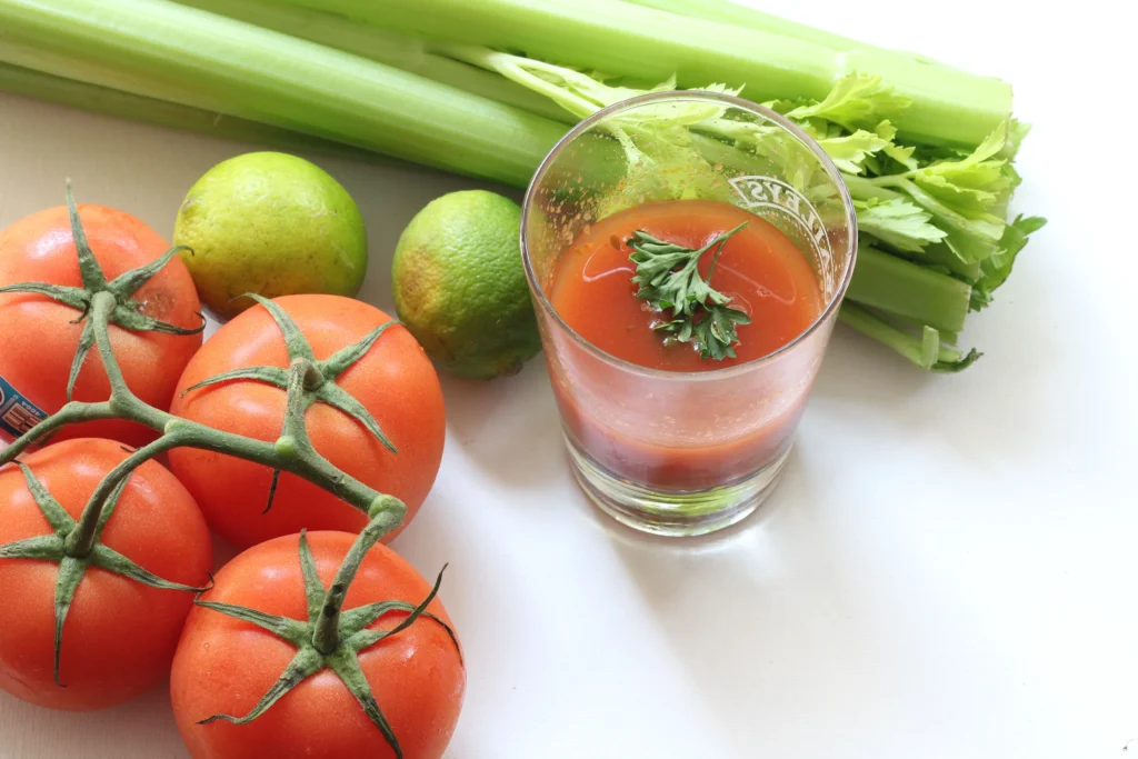 Flavor-packed Bloody Mary cocktail garnished with celery, lemon, olives, and spices in a tall glass.