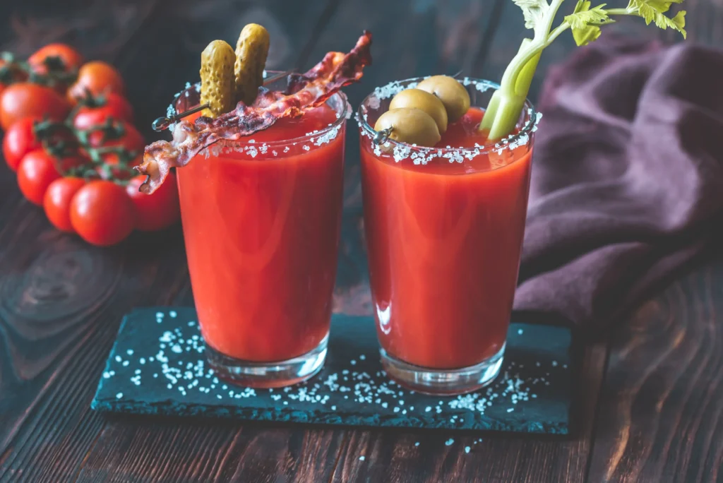 Flavor-packed Bloody Mary cocktail garnished with celery, lemon, olives, and spices in a tall glass.