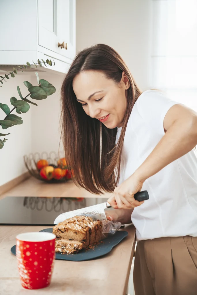 Freshly baked chocolate chip banana bread sliced on a wooden board, filled with melted chocolate chips and made with ripe bananas, perfect for beginner bakers.