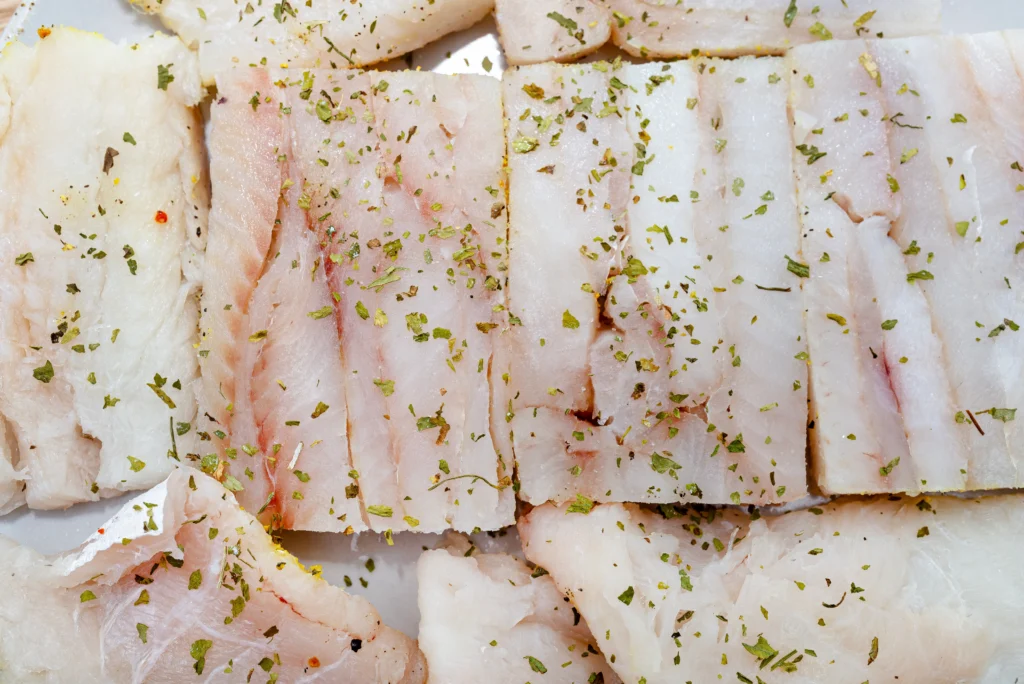 Sea Bass Recipe
Oven-baked Chilean sea bass with garlic and fresh herbs on a white plate
