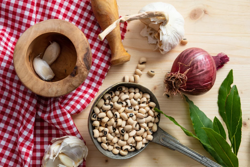 A bowl of traditional Hoppin' John made with black-eyed peas, rice, smoked sausage, and Southern seasonings, garnished with fresh herbs.