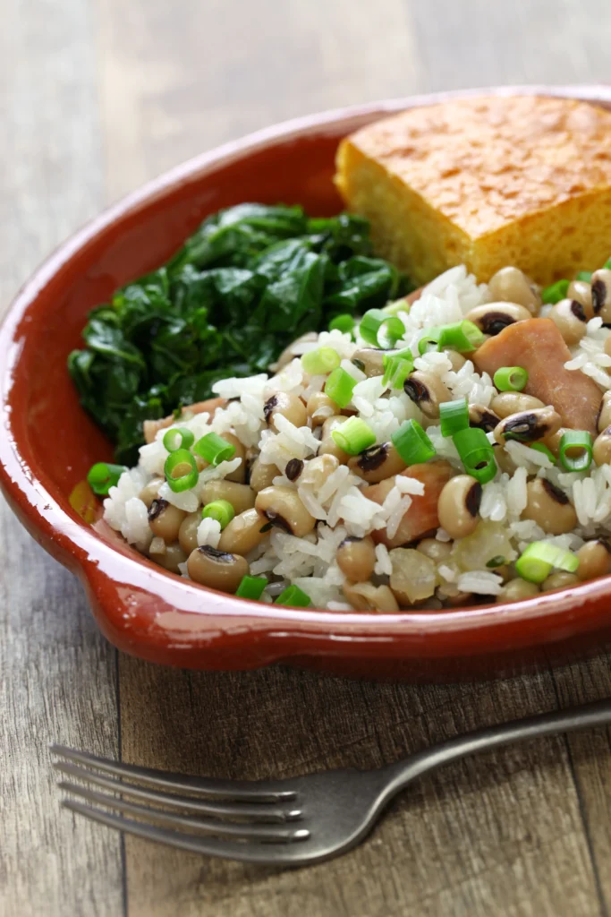 A bowl of traditional Hoppin' John made with black-eyed peas, rice, smoked sausage, and Southern seasonings, garnished with fresh herbs.