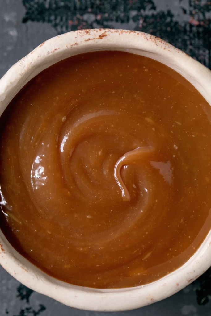 Brown gravy recipe in a skillet, rich homemade gravy with smooth texture, served with mashed potatoes.