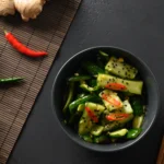 Low-calorie Korean cucumber salad served in a bowl with sesame seeds and chili flakes