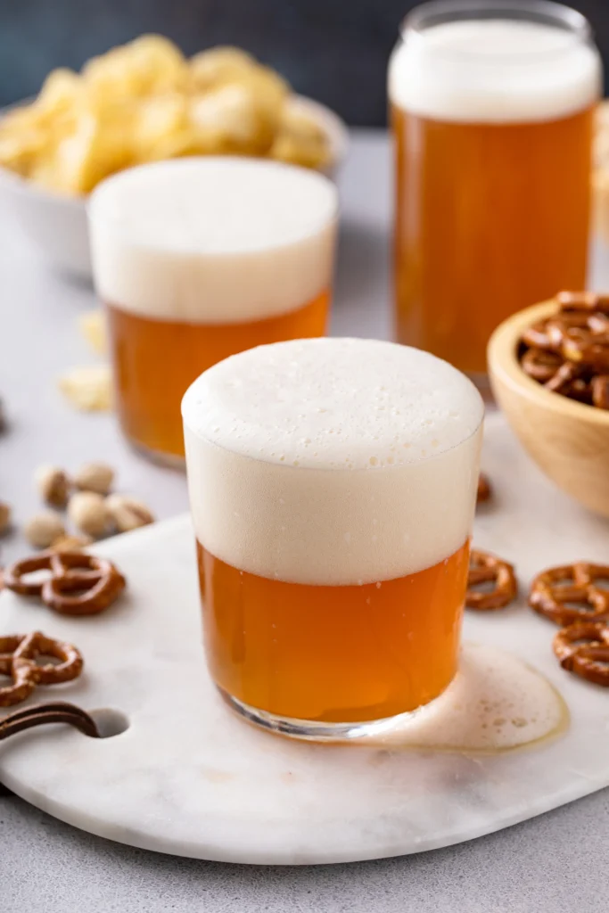 Cold and hot Butterbeer recipe ideas inspired by Harry Potter, featuring creamy foam, butterscotch drink, and cozy wizarding world vibes.