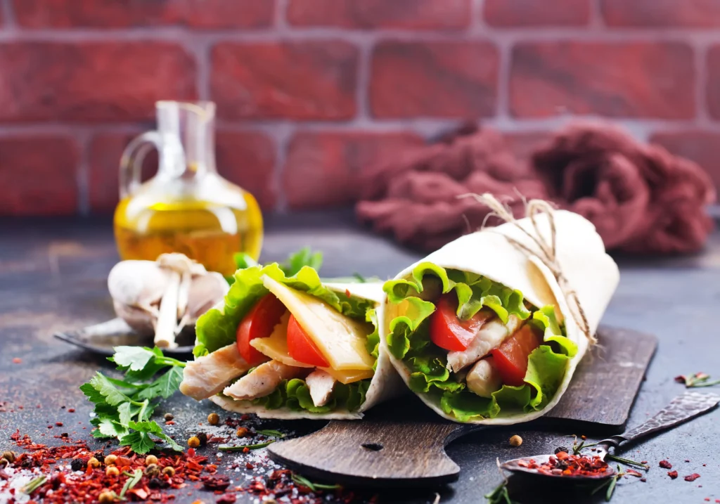 Grilled Chicken Caesar Wraps filled with juicy grilled chicken, crisp romaine lettuce, Parmesan cheese, and creamy Caesar dressing wrapped in a soft tortilla.