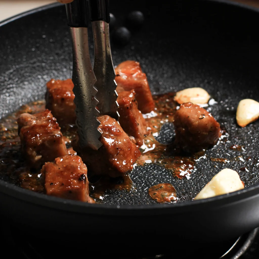Garlic Butter Steak Bites cooked to perfection in a skillet, coated in rich garlic butter sauce and garnished with fresh parsley.