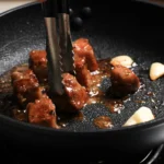 Garlic Butter Steak Bites cooked to perfection in a skillet, coated in rich garlic butter sauce and garnished with fresh parsley.