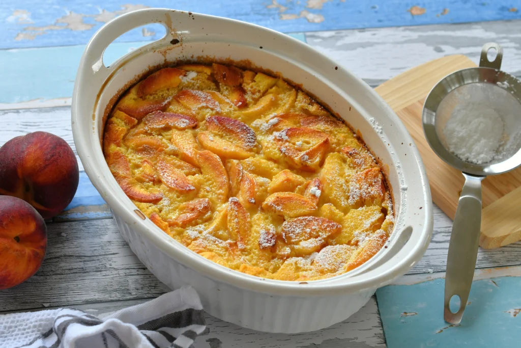 Peach Spoon Cake Recipe
Fresh peach spoon cake served warm in a rustic baking dish, topped with juicy sliced peaches and a golden buttery cake layer, perfect for a comforting summer dessert.