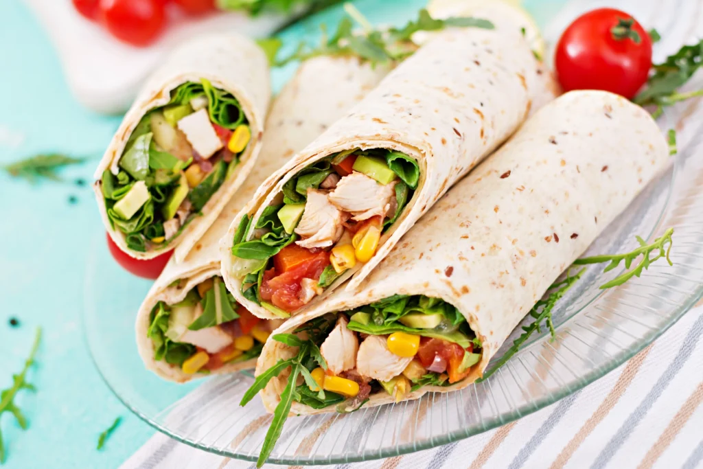 Grilled Chicken Caesar Wraps filled with juicy grilled chicken, crisp romaine lettuce, Parmesan cheese, and creamy Caesar dressing wrapped in a soft tortilla.