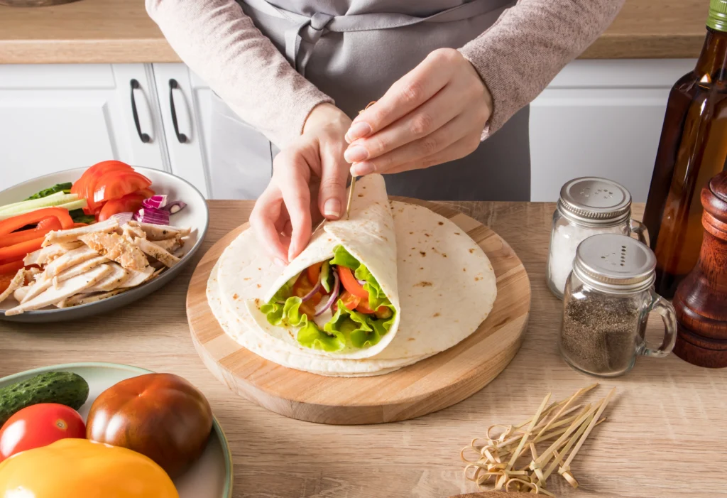 Grilled Chicken Caesar Wraps filled with juicy grilled chicken, crisp romaine lettuce, Parmesan cheese, and creamy Caesar dressing wrapped in a soft tortilla.