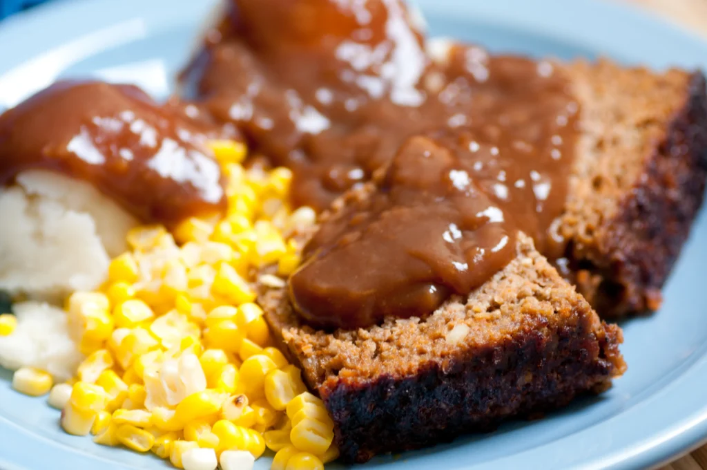 Brown gravy recipe in a skillet, rich homemade gravy with smooth texture, served with mashed potatoes.
