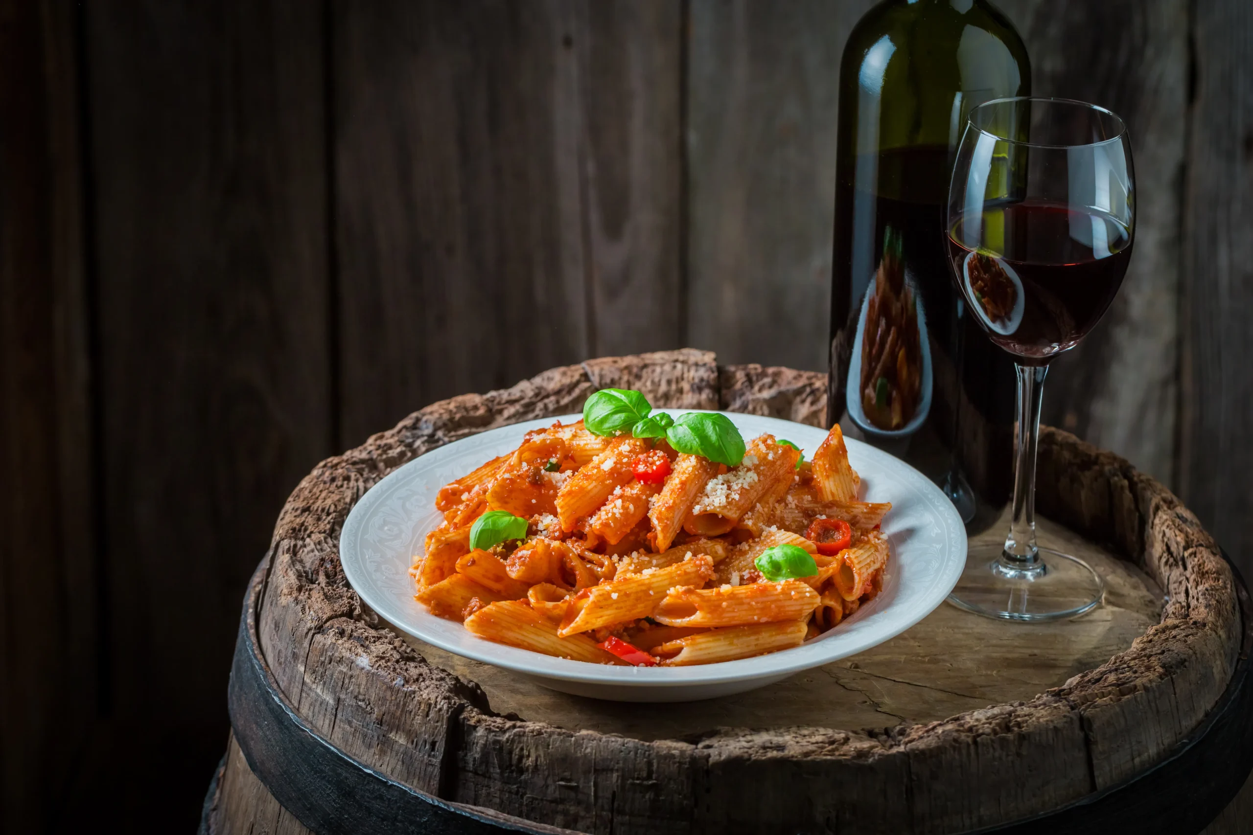 Creamy Penne alla Vodka pasta served in a bowl with rich tomato cream sauce, Parmesan cheese, and fresh basil garnish.