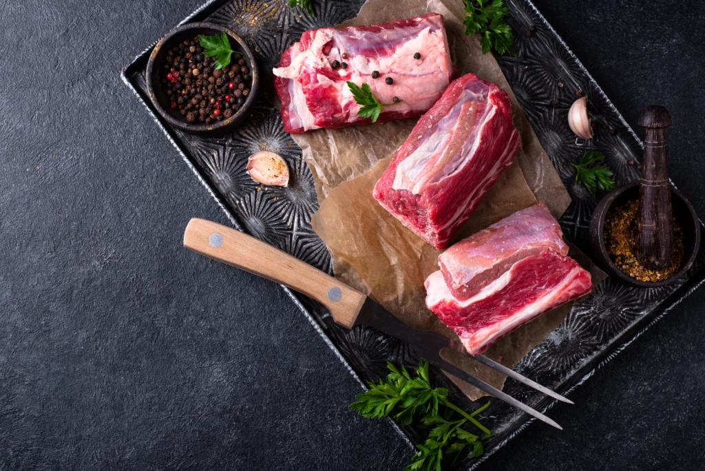 Fall-Off-The-Bone Braised Short Ribs served with rich sauce and vegetables on a rustic plate