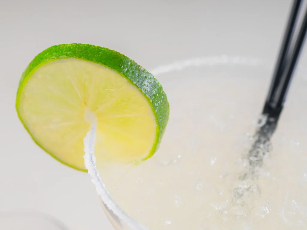 Refreshing skinny margarita recipe in a glass with fresh lime and ice