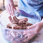 Fall-Off-The-Bone Braised Short Ribs served with rich sauce and vegetables on a rustic plate