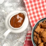Brown gravy recipe in a skillet, rich homemade gravy with smooth texture, served with mashed potatoes.