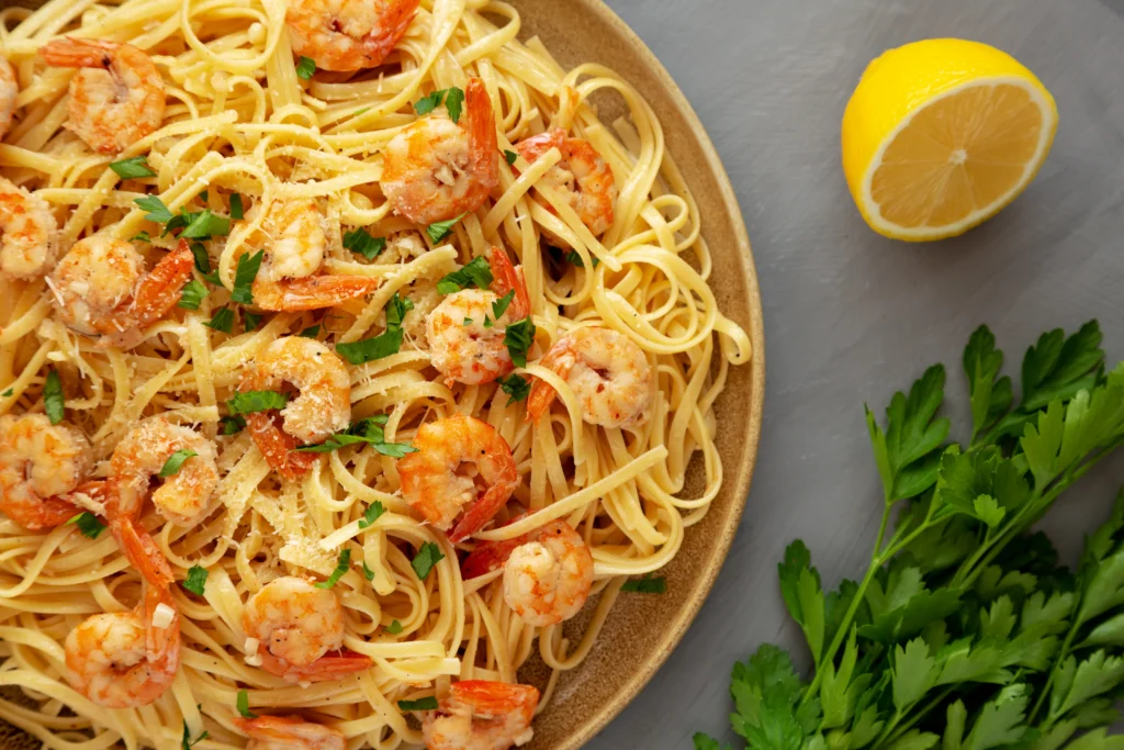 Garlic Butter Shrimp Pasta served with tender linguine, juicy sautéed shrimp, garlic butter sauce, fresh parsley, and grated Parmesan.