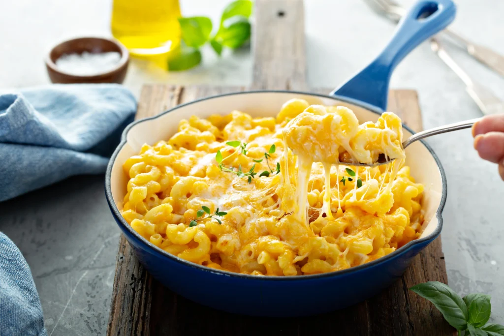 Creamy homemade mac and cheese baked until golden brown with a rich, cheesy sauce, served in a white baking dish just like Grandma's classic comfort food recipe.