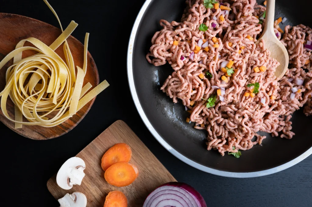 Creamy Ground Beef Stroganoff served over egg noodles with mushrooms and fresh parsley