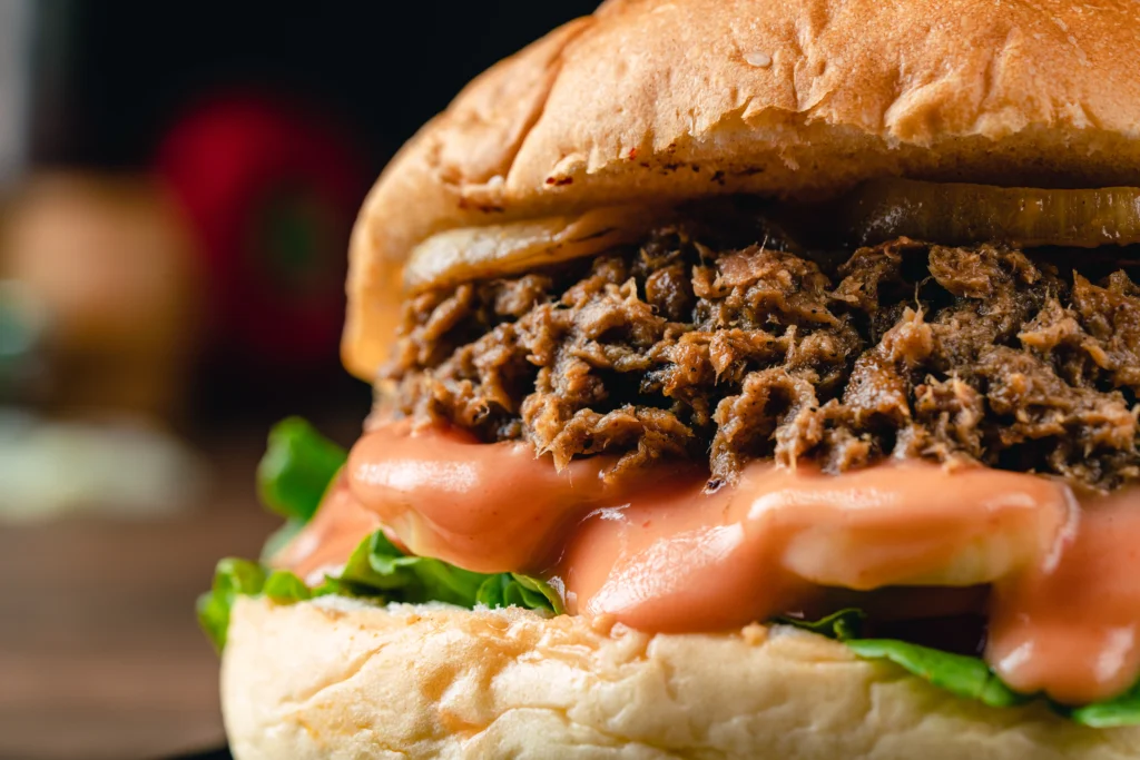 Juicy homemade smash burger with crispy beef patties, melted cheddar cheese, fresh lettuce, tomato, pickles, and a toasted brioche bun served with golden French fries.