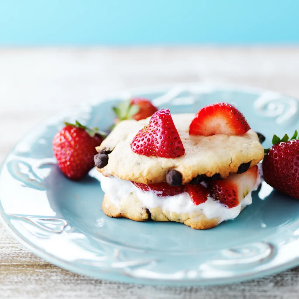 Strawberry Shortcake Recipe
Homemade strawberry shortcake with fluffy biscuits, fresh sliced strawberries, and whipped cream served on a white dessert plate.