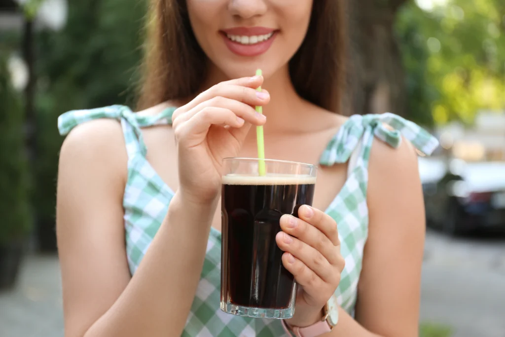 Restaurant-quality homemade iced coffee in a glass with ice, milk, and coffee foam