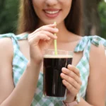 Restaurant-quality homemade iced coffee in a glass with ice, milk, and coffee foam