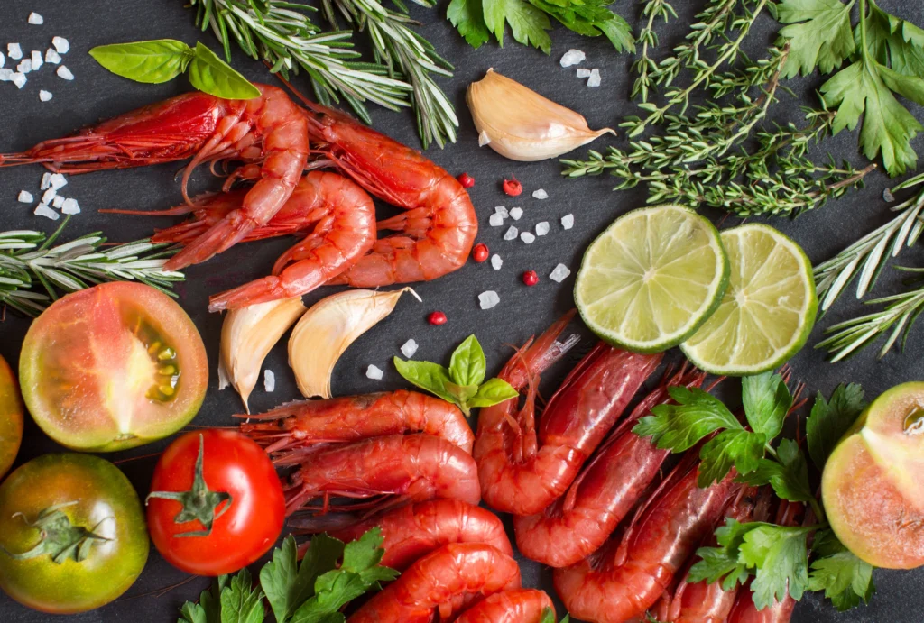 Smoky shrimp with sliced chorizo cooked in a rich paprika-infused sauce, garnished with fresh parsley and served in a rustic skillet with lemon wedges.