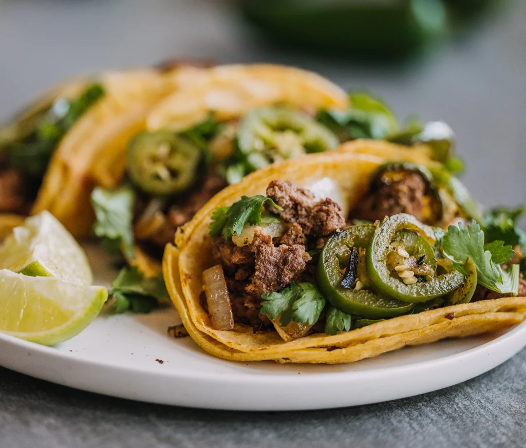 Homemade smash burger tacos with crispy beef, melted cheese, lettuce, and pickles