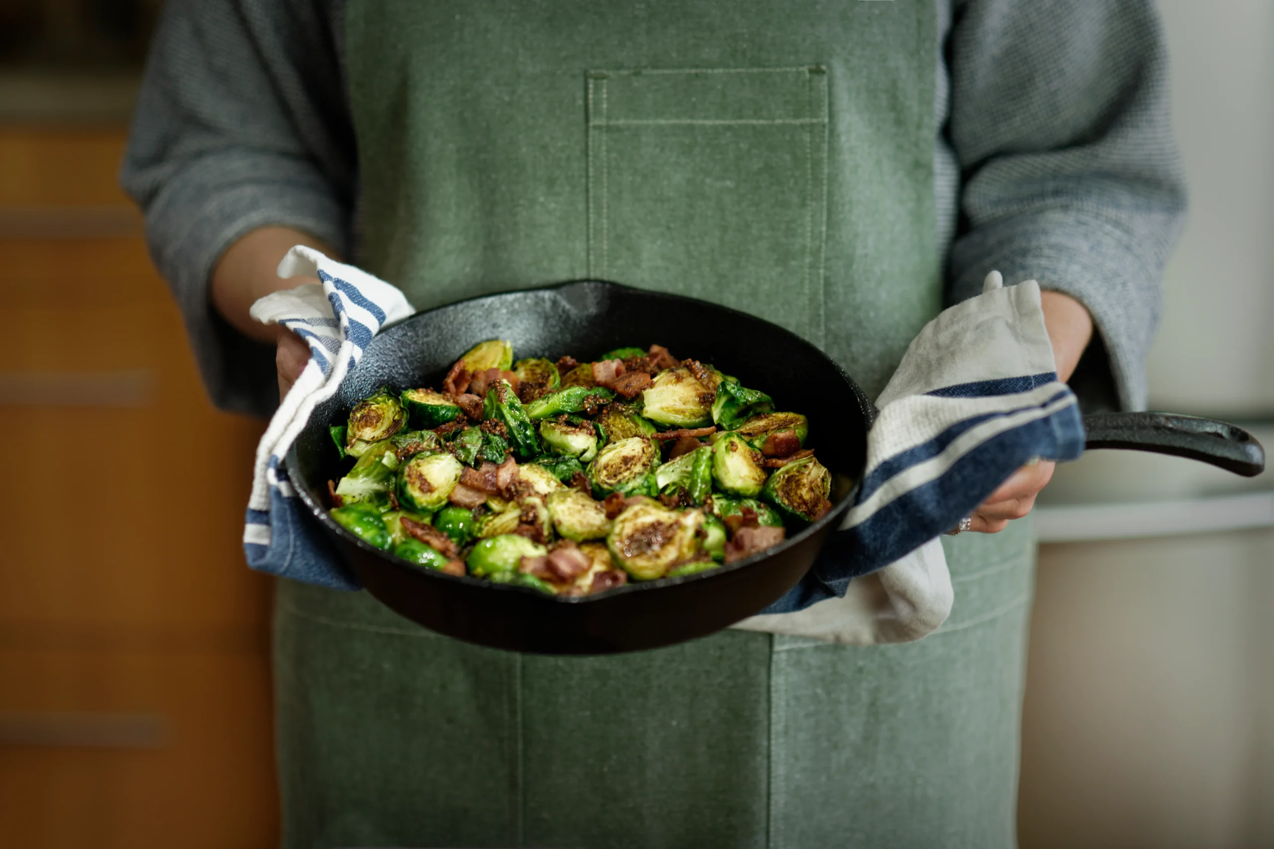 Sausage and Brussels sprouts stir-fry with caramelized vegetables in a skillet