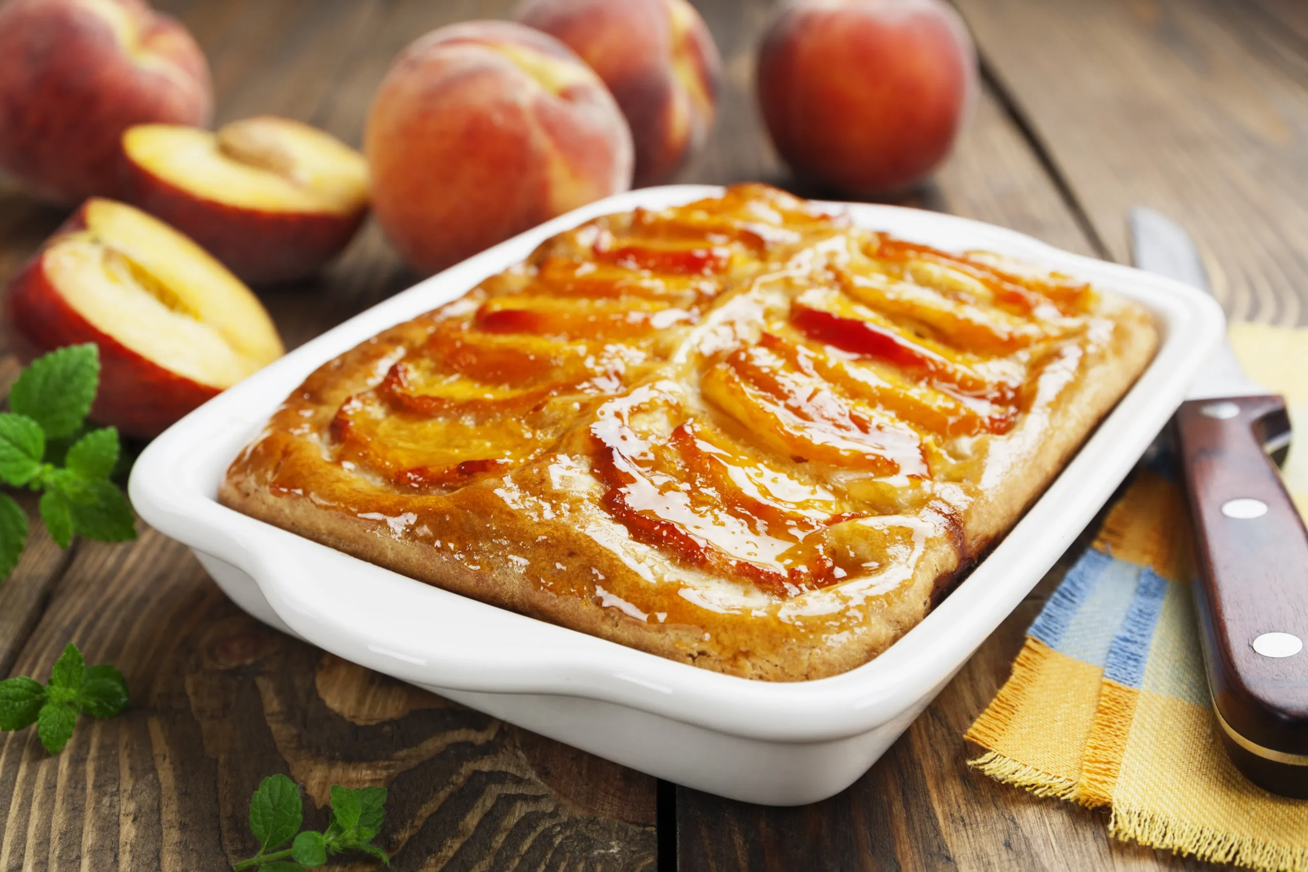 Classic homemade Peach Cobbler with fresh peaches and golden topping