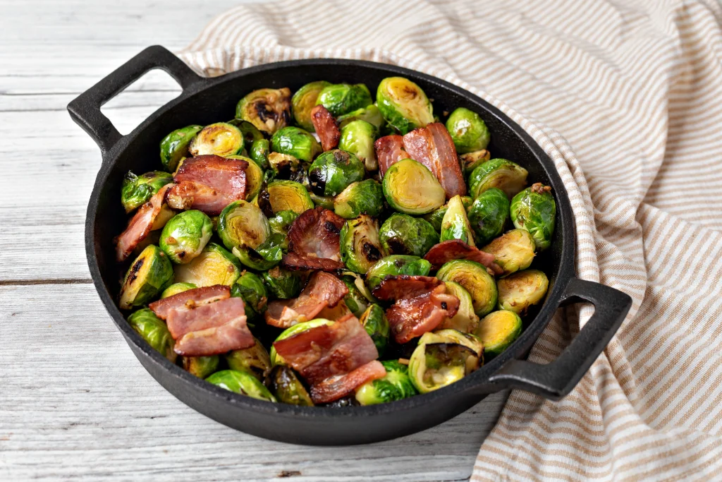 Sausage and Brussels sprouts stir-fry with caramelized vegetables in a skillet