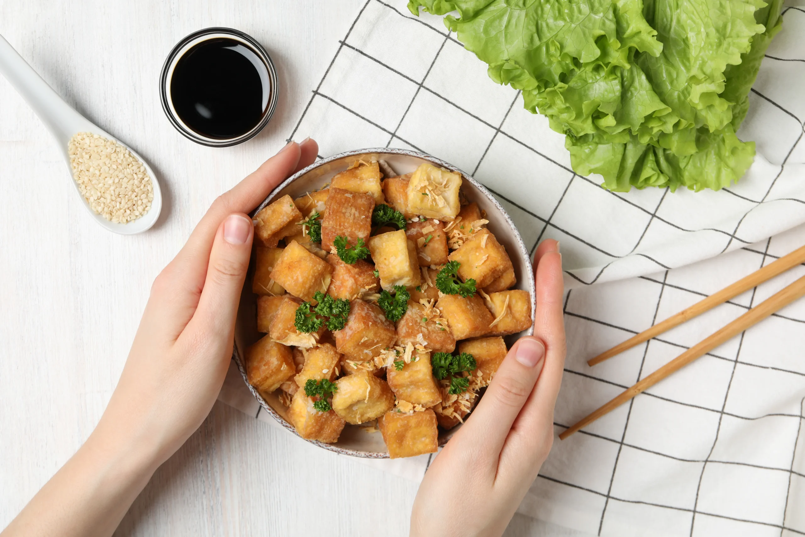 Crispy tofu with creamy peanut sauce served with rice and vegetables