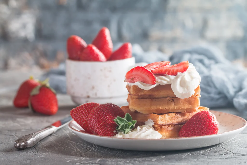 Homemade strawberry shortcake with fresh strawberries, whipped cream, and golden biscuit layers
