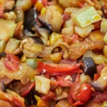 Sicilian caponata with eggplant, tomatoes, olives, and capers served as a sweet and sour Italian dish